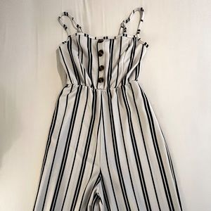 Long white/black jumpsuit. Covers ankles.